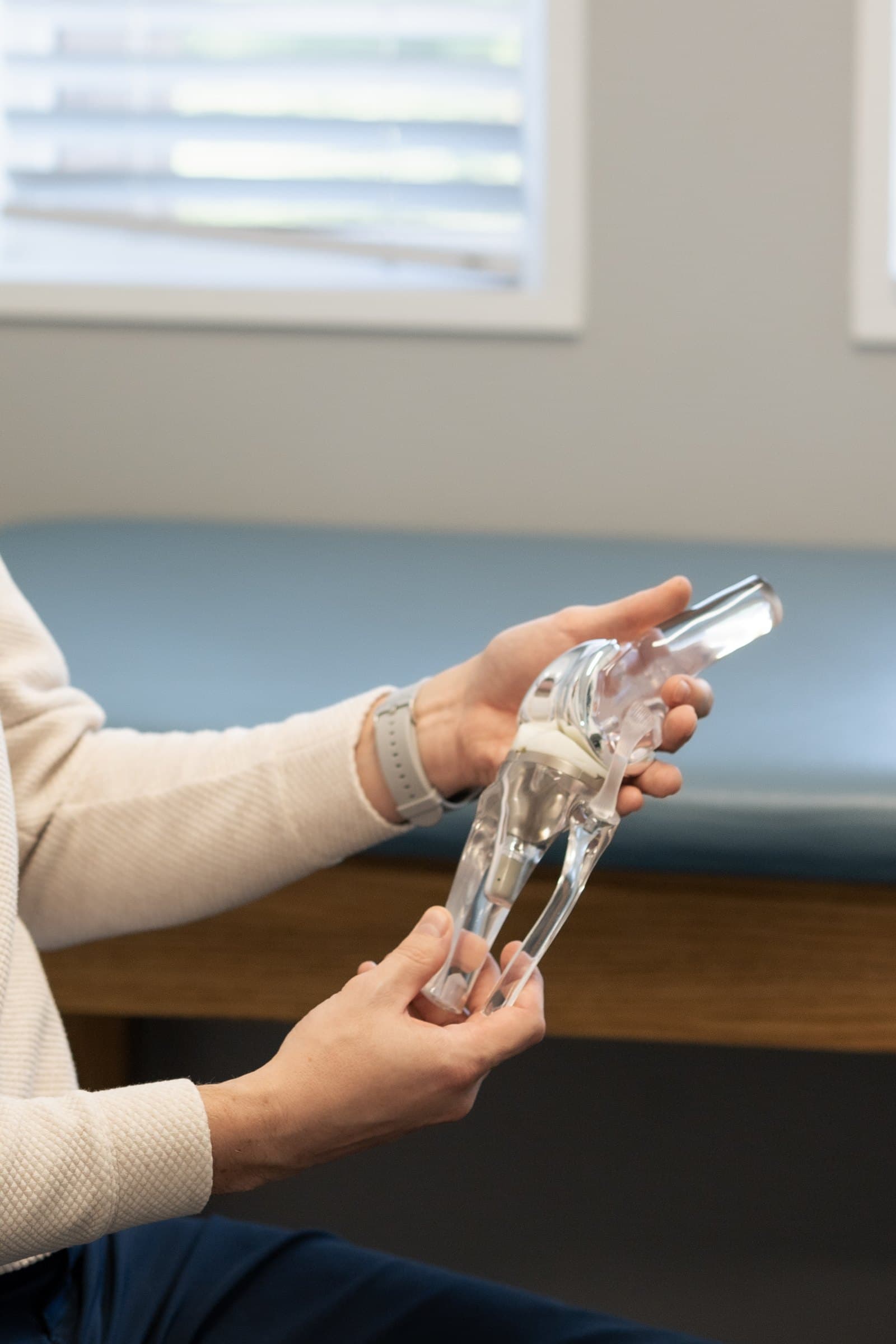 Dr. Seem holding a knee replacement demonstration model